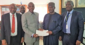Managing Director/Chief Executive Officer, Asset Management Corporation of Nigeria (AMCON), Mr Ahmed Kuru (2nd left) handing over a document to the Director-General, Bureau of Public Procurement (BPP), Mr Mamman Ahmadu (2nd right) at BPP Head, Office, State House, Abuja during a strategic partnership meeting on the recovery of AMCON debt. They are flanked by Mr Saidu Jallo, Company Secretary/Legal Adviser, AMCON and Mr Sulaiman Abdul Majeed, Head, Enterprise Risk Management, AMCON.