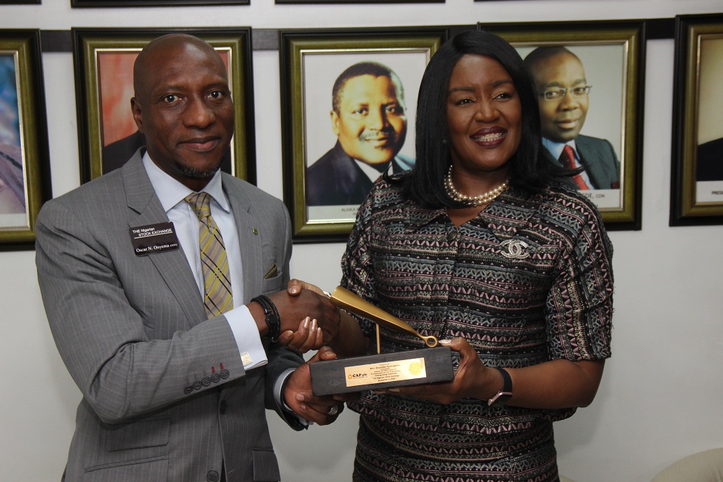 L – R shows Mr. Oscar N. Onyema, OON, Chief Executive Officer, The Nigerian Stock Exchange (NSE) presenting a replica of the closing gong to Mrs. Awuneba Ajumogobia, Chairperson, CAP Plc during a Closing Gong Ceremony to introduce their newly appointed Board Members and Executive Management to the capital market stakeholders at the Exchange today in Lagos.   