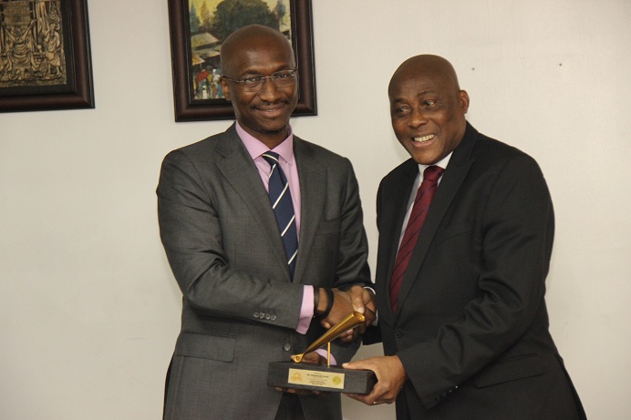 L – R (Pix 3) shows  Mr. Bola Adeeko, Head, Corporate Services Division, NSE presenting a replica copy of closing gong to  Mr. Babatunde Kasali, Chairman of the Board of UPDC Plc during the Facts Behind the Right Issue presentation at the Exchange today in Lagos