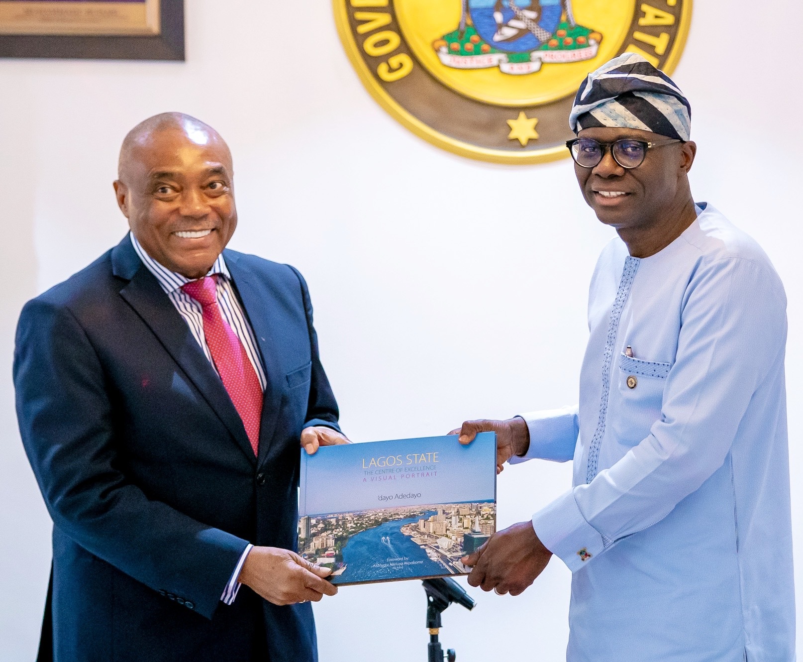 L-R: Independent Non-Executive Director of Dangote Cement Plc, Mr. Emmanuel Ikazoboh, receiving a compendium from Lagos State Governor, Mr. Babajide Sanwo-Olu, during a courtesy visit to the Governor by the executive management of Dangote Cement Plc at Lagos House, Marina, on Wednesday, March 18, 2020.