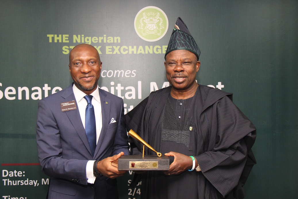 L – R shows: Mr. Oscar N. Onyema, OON, Chief Executive Officer, The Nigerian Stock Exchange presenting a replica of the closing gong to H.E. Sen. Ibikunle Amosun, CON, Chairman, Senate Committee on Capital Market during the Senate Committee on Capital Market’s courtesy visit to The Exchange on Thursday, March 19, 2020.