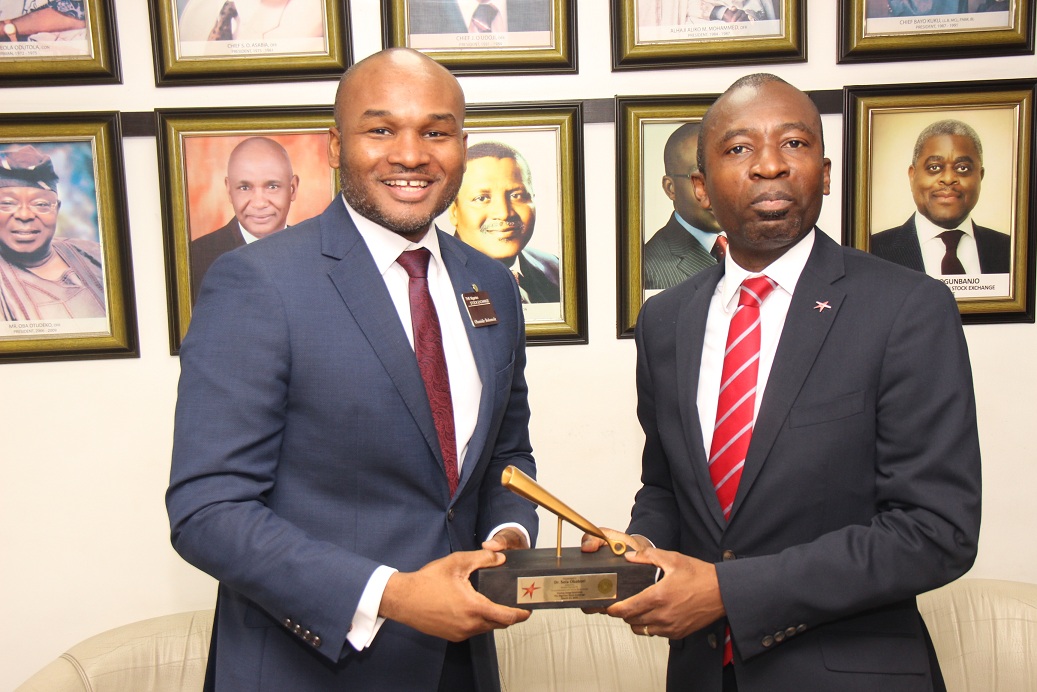L – R shows Olumide Bolumole, Head, Listings Business Division, The Nigerian Stock Exchange (NSE) presenting a replica of the closing gong to Sola Obabori, Group Managing Director/Chief Executive Officer, Red Star Express Plc during the Closing Gong Ceremony to commemorate the success of their rights issue and listing of additional shares at the Exchange today in Lagos.