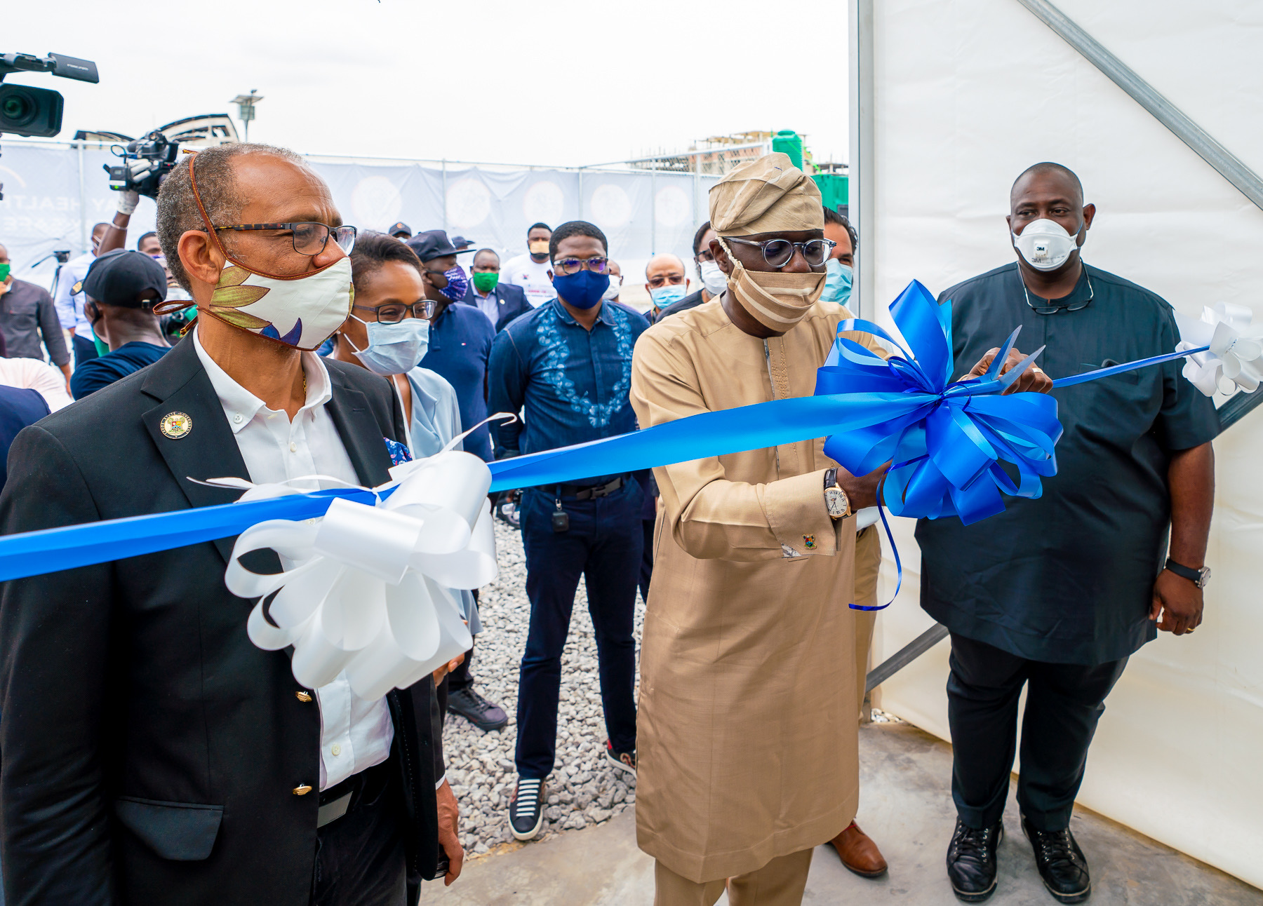 Lagos State Governor, Mr. Babajide Sanwo-Olu (middle), cutting the tape to unveil the 80-Bed Isolation Centre, with Ten Intensive Care Unit facility, Four Ventilators for COVID-19 treatment, at Landmark Convention Centre, Oniru, on Wednesday, April 22, 2020. With him is the Commissioner for Health, Prof. Akin Abayomi (left) and others.