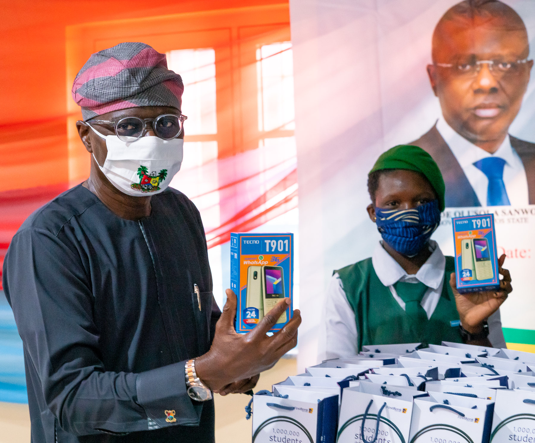 L-R: Lagos State Governor, Mr. Babajide Sanwo-Olu, with beneficiary, Miss Sherifat Umar of Elegbata Senior High school, Lagos Island, during the presentation of 20,000 E-Learning devices for Lagos State Schools by First Bank at the Lagos House, Marina, on Thursday, June 11, 2020.
