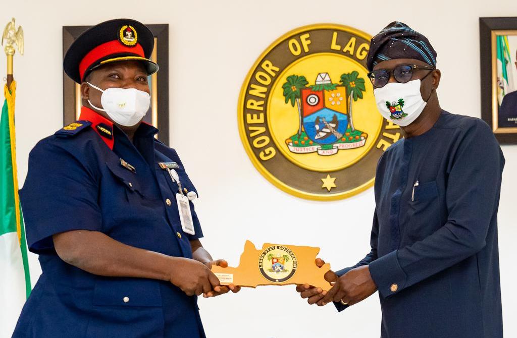 L-R: State Commandant, Nigeria Security and Civil Defence Corps (NSCDC) Lagos, Mr. Adeyinka Fasiu Ayinla, receiving a souvenir from Lagos State Governor, Mr. Babajide Sanwo-Olu during a courtesy call on the Governor, at Lagos House, Marina, on Thursday, July 23, 2020.