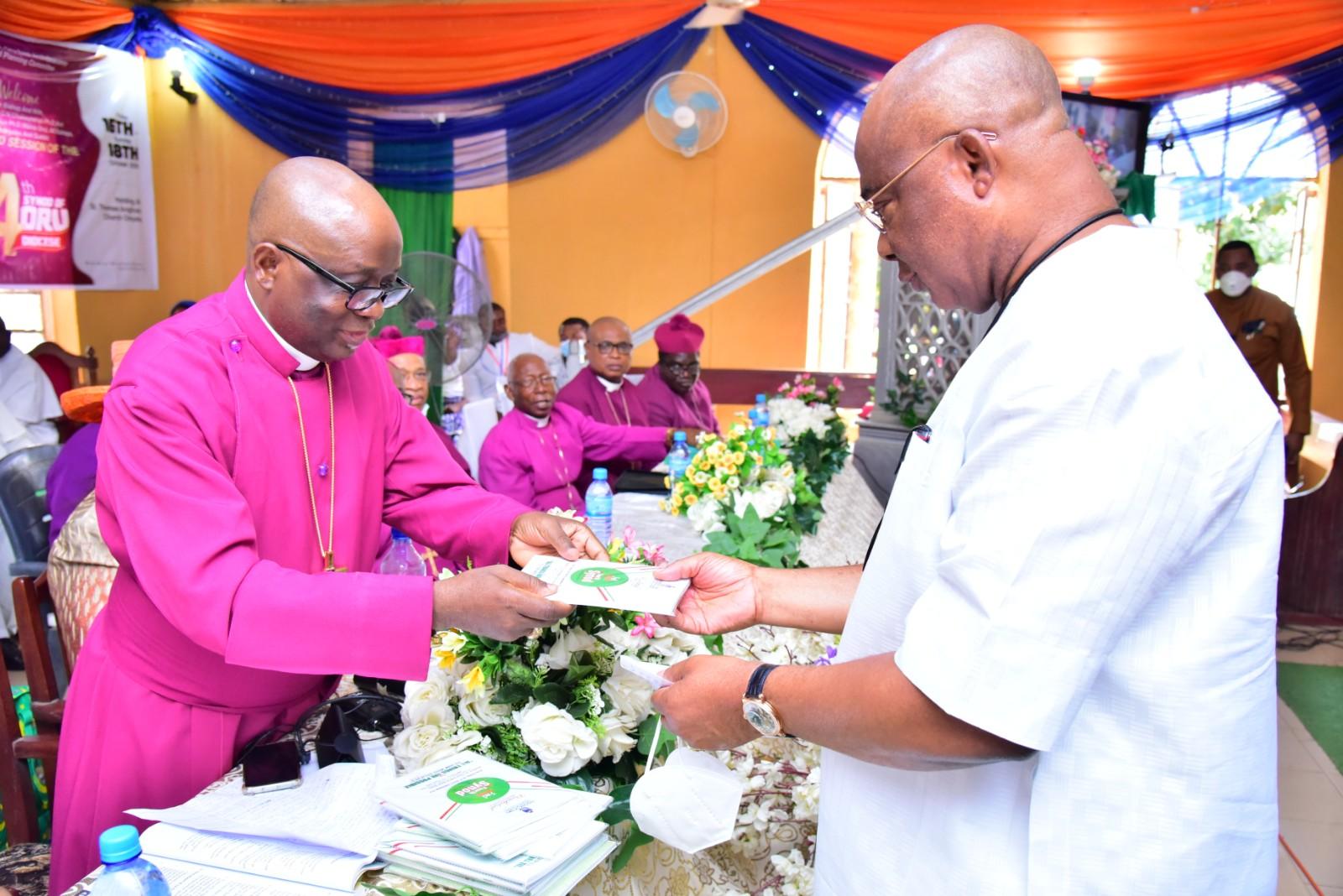 Governor Hope Uzodimma receiving a copy of the Presidential Address/Charge to the Synod from the Bishop of Oru Anglican Communion Rt. Rev. Geoffrey Chukwuneye when the Governor attended the Diocesan Synod held at St. Thomas Anglican Church, Omuma Oru-East LGA…weekend.