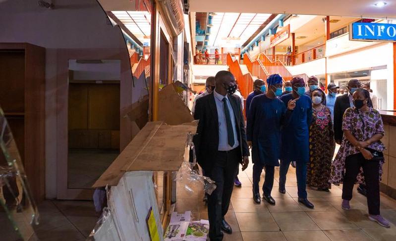 L-R: Lagos State Deputy Governor, Dr. Obafemi Hamzat (left); Governor Babajide Sanwo-Olu (second left) and an Operator at Adeniran Ogunsanya Mall, Mrs. Toyin Bakare during an on-the-spot assessment of the vandalised Adeniran Ogunsanya Mall in Surulere, on Tuesday, October 27, 2020.