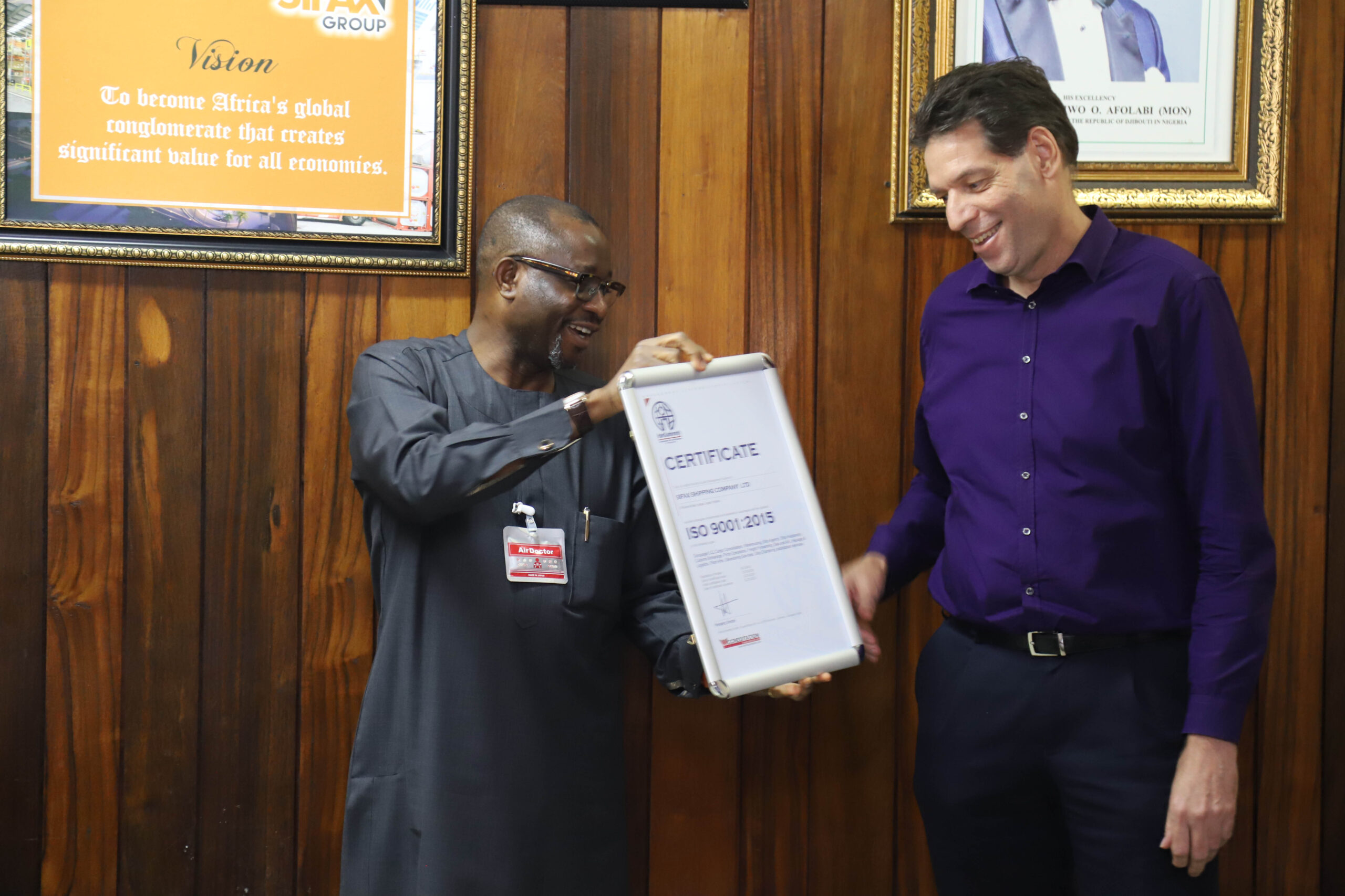 Adekunle Oyinloye, Group Managing Director, SIFAX Group presenting one of the ISO 9001:2015 certificates to Paul vd Linden, Managing Director, SIFAX Logistics Company Limited.