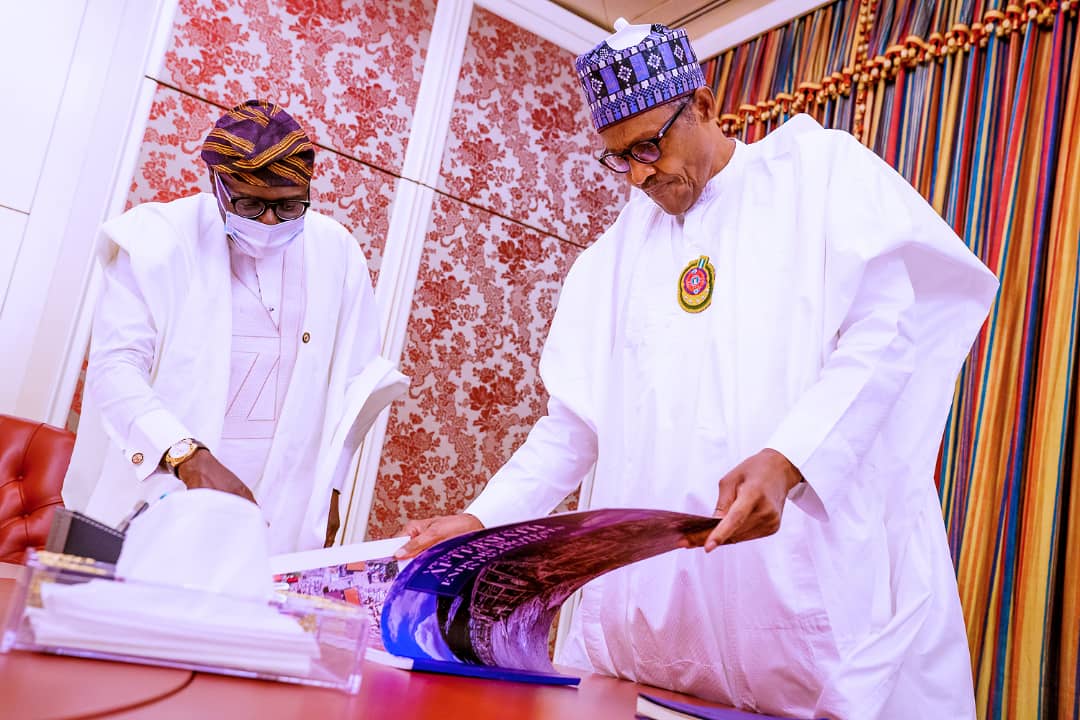 L-R: Lagos State Governor, Mr. Babajide Sanwo-Olu with President Muhammadu Buhari, during his presentation of the pictorial report of the aftermath of EndSARS protest in Lagos, at the Presidential Villa, Abuja on Friday, November 6, 2020